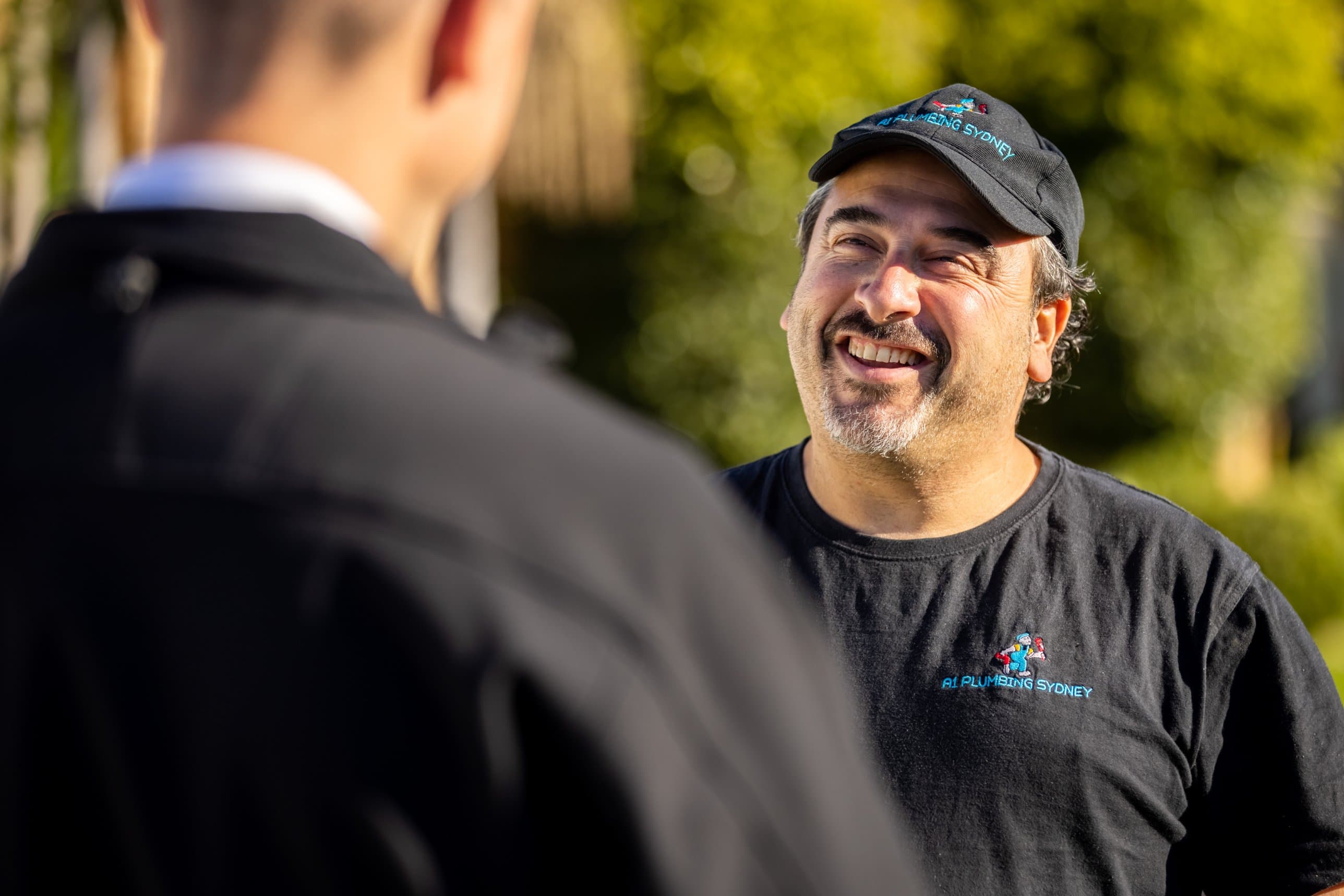 A trade business owner laughing during a conversation with Jared